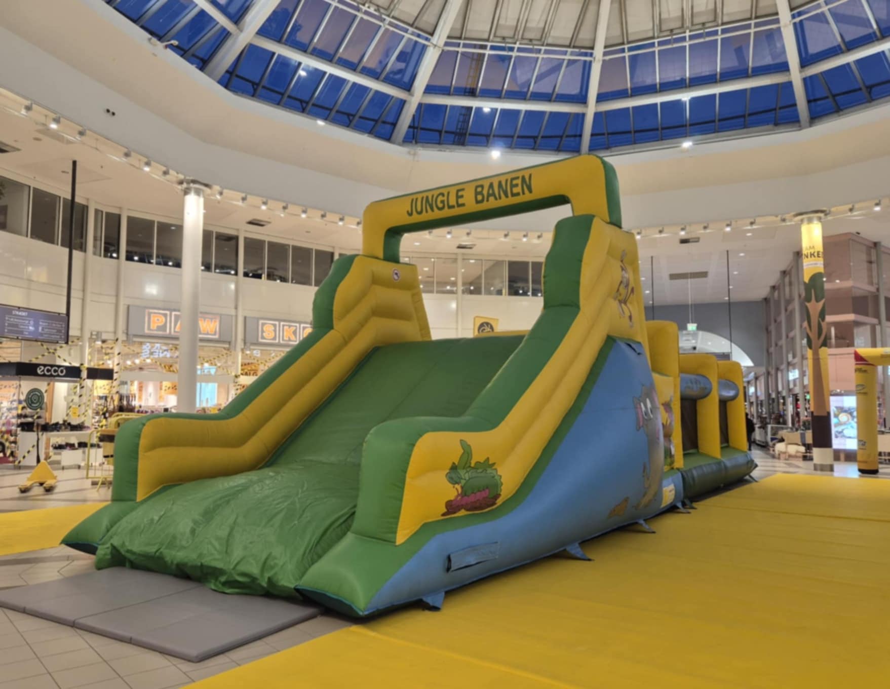 Eight shirts arranged on table in black, olive, grey, blue, white, red, mustard, and green.