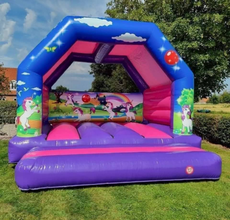 Eight shirts arranged on table in black, olive, grey, blue, white, red, mustard, and green.
