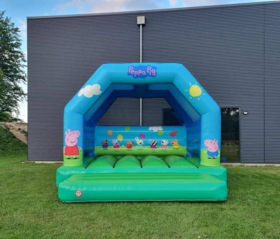 Eight shirts arranged on table in black, olive, grey, blue, white, red, mustard, and green.