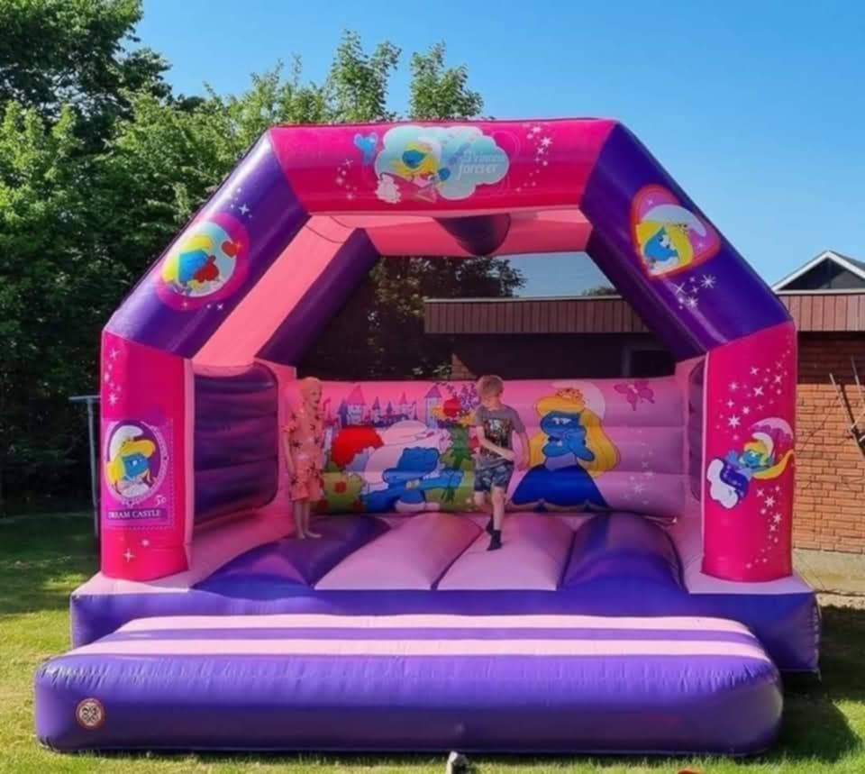 Eight shirts arranged on table in black, olive, grey, blue, white, red, mustard, and green.