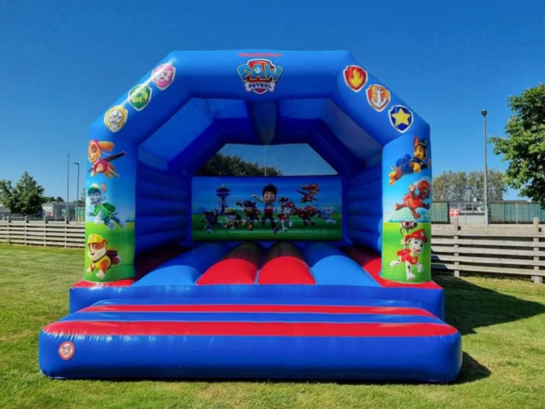 Eight shirts arranged on table in black, olive, grey, blue, white, red, mustard, and green.