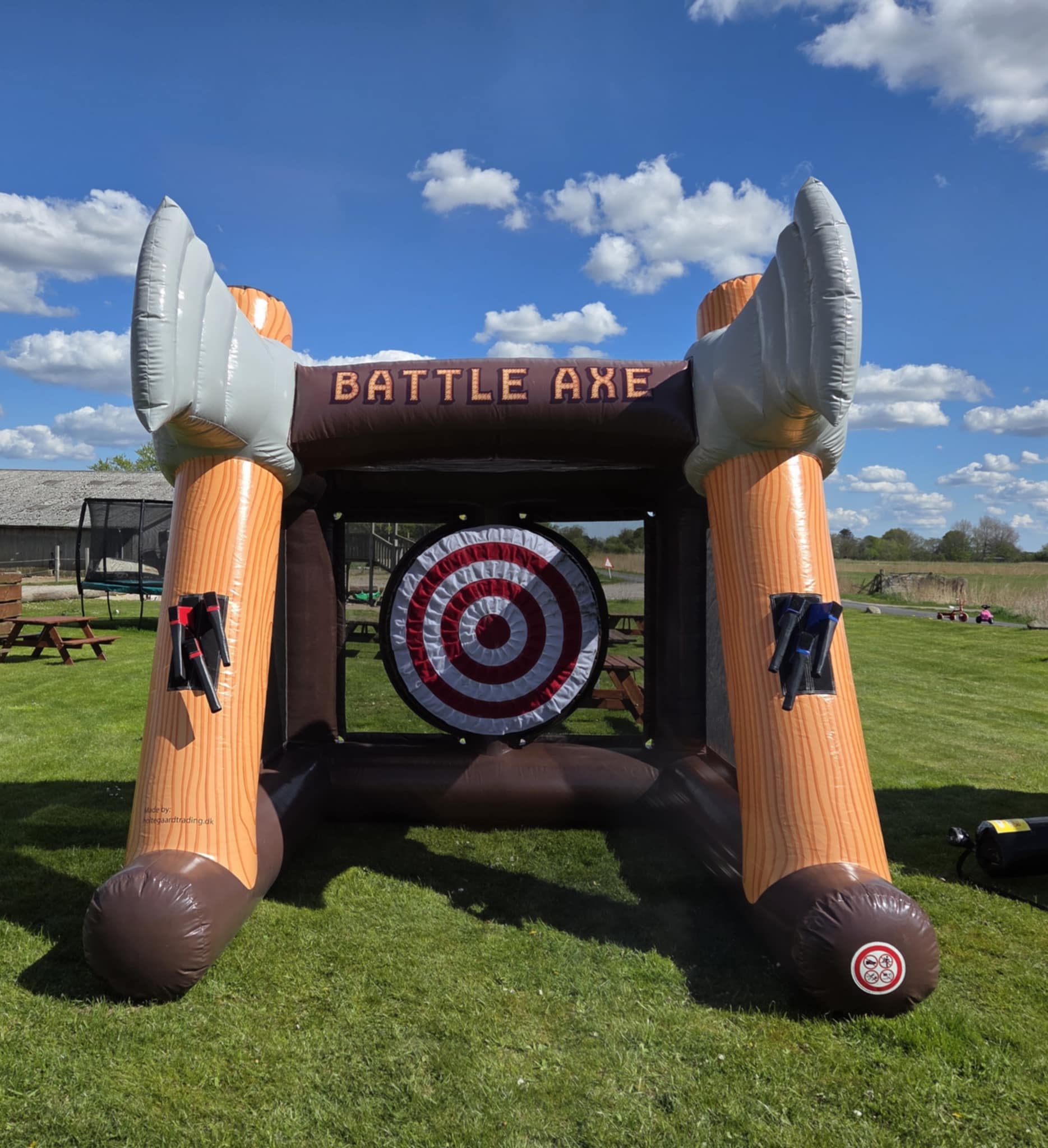 Eight shirts arranged on table in black, olive, grey, blue, white, red, mustard, and green.