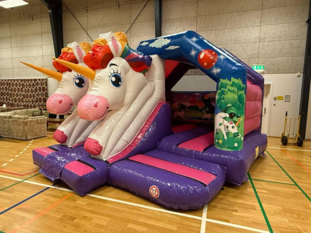 Eight shirts arranged on table in black, olive, grey, blue, white, red, mustard, and green.