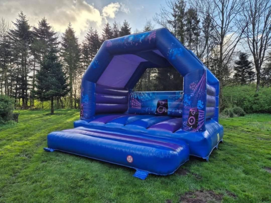 Eight shirts arranged on table in black, olive, grey, blue, white, red, mustard, and green.