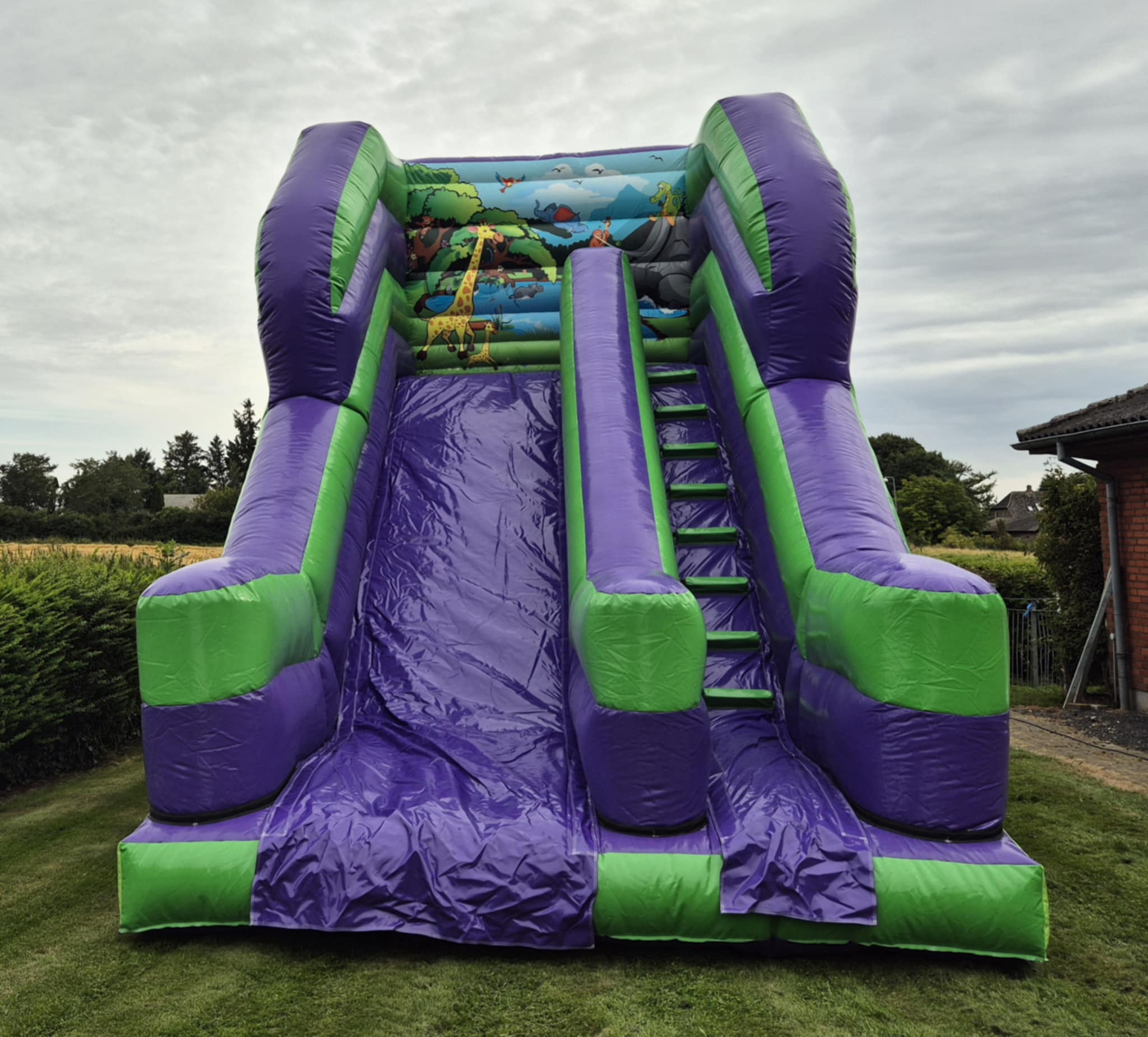 Eight shirts arranged on table in black, olive, grey, blue, white, red, mustard, and green.