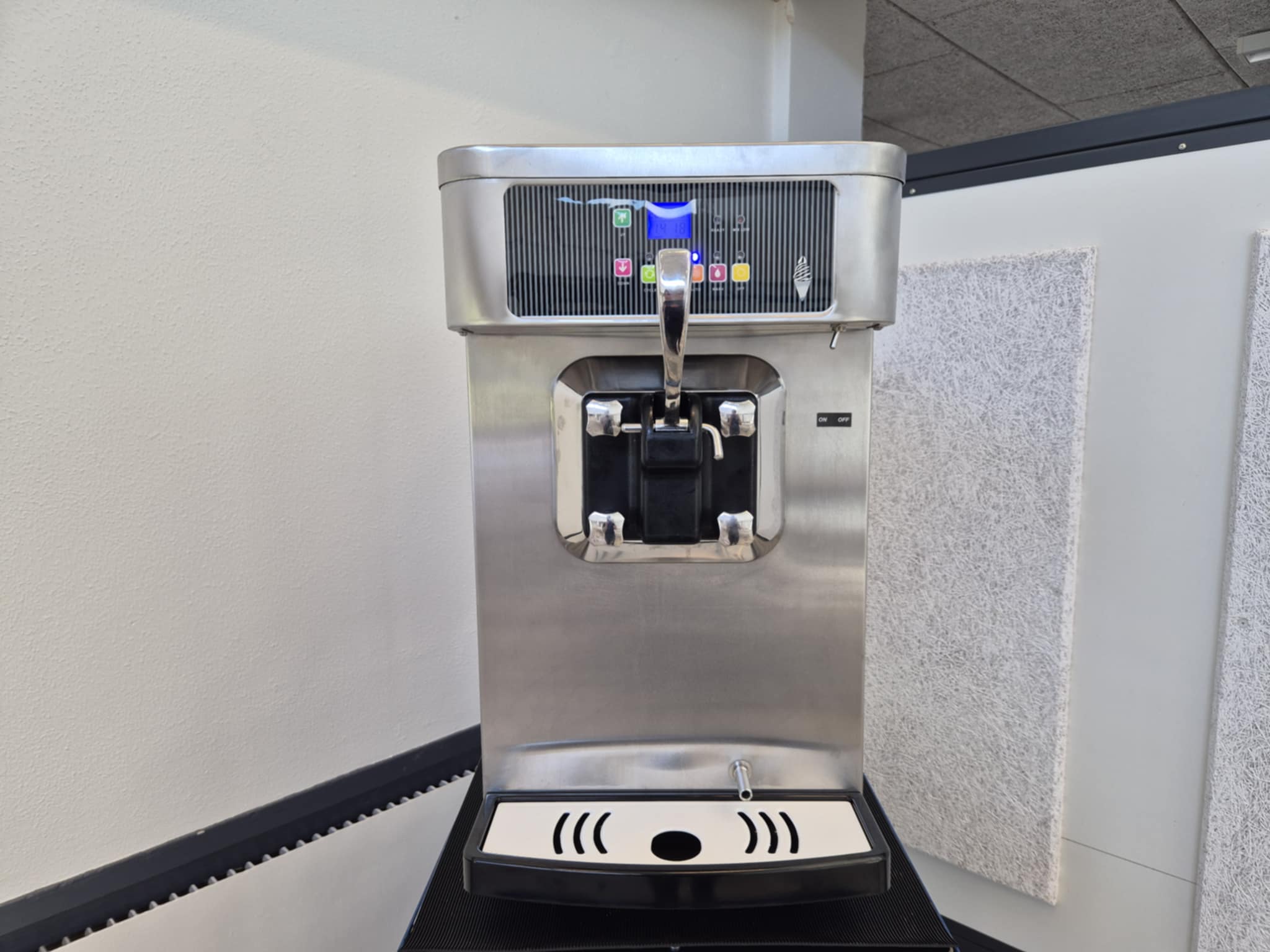 Eight shirts arranged on table in black, olive, grey, blue, white, red, mustard, and green.