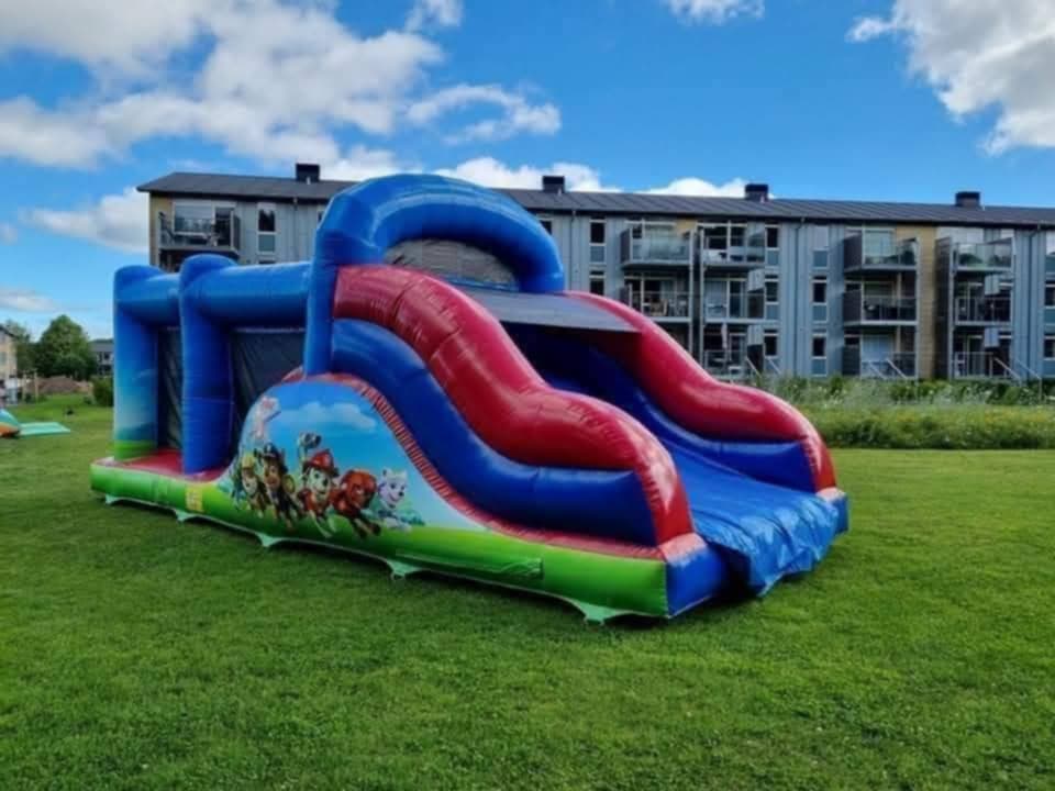 Eight shirts arranged on table in black, olive, grey, blue, white, red, mustard, and green.