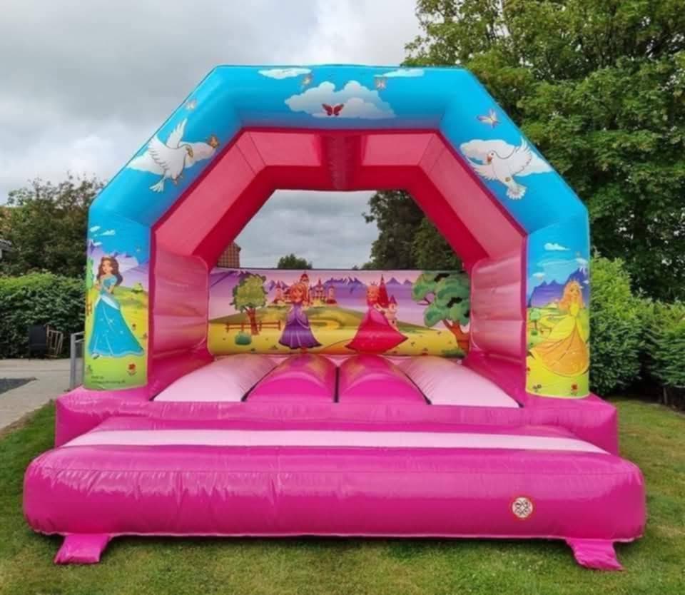 Eight shirts arranged on table in black, olive, grey, blue, white, red, mustard, and green.